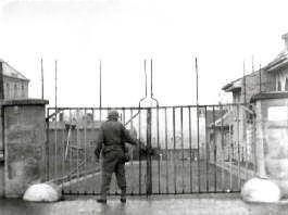 US soldier at gates of Stalag 13, Germany, 1945