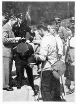 Hitler signing autograph on back of SS man Hitler signing autograph on back of SS man