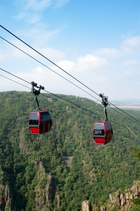 Red gondolas on the aerial tramway from Thale to the Hexentanzplatz, Harz Mountains, Germany